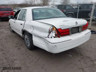2004 Mercury Grand Marquis GS with VIN 2MEFM74W24X628573, listed as a IAAI auction lot 41922123 with 104,395 mi miles. Bid and sale history available at carsss.com. Image 3.