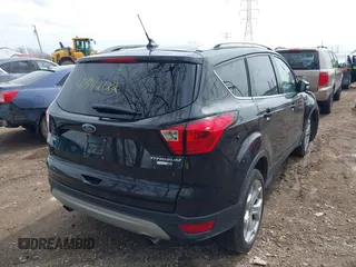 2019 Ford Escape Titanium with VIN 1FMCU9J91KUC42161, listed as a IAAI auction lot 41942122 with 100,677 mi miles and . Bid and sale history available at DreamBid. Image 4.