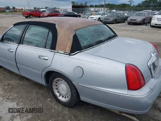 1998 Lincoln Town Car Signature with VIN 1LNFM82WXWY659028, listed as a IAAI auction lot 42265774 with 164,400 mi miles and . Bid and sale history available at DreamBid. Image 3.