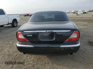 2004 Jaguar XJ with VIN SAJEA71C54SG01455, listed as a Copart auction lot 86591014 with 83,977 mi miles and Salvage Title. Bid and sale history available at carsss.com. Image 6.