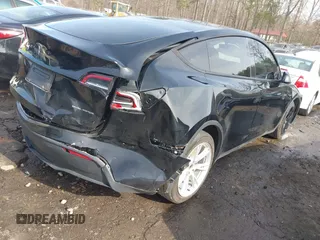 2023 Tesla Model Y Long Range z VIN 7SAYGAEE5PF603128, wystawiony jako IAAI lot #41328797 z przebiegiem 63 527 mil mil oraz . Historia ofert i sprzedaży dostępna na DreamBid. Obrazek 4.