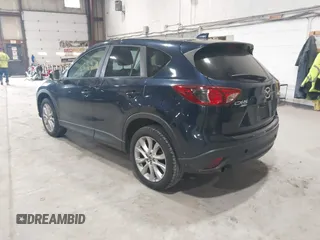 2015 Mazda CX-5 Grand Touring z VIN JM3KE4DYXF0490920, wystawiony jako IAAI lot #42367194 z przebiegiem 80 436 mil mil oraz . Historia ofert i sprzedaży dostępna na DreamBid. Obrazek 3.