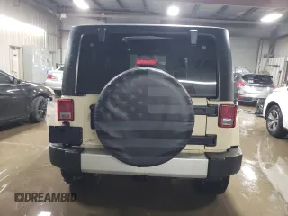 2011 Jeep Wrangler Sahara with VIN 1J4AA5D19BL577347, listed as a Copart auction lot 80340124 with 148,986 mi miles and Salvage Title. Bid and sale history available at DreamBid. Image 6.