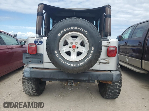 2003 Jeep Wrangler Rubicon z VIN 1J4FA69S53P340085, wystawiony jako Copart lot #74564574 z przebiegiem Nie podano mil oraz Szkoda całkowita • Salvage title. Historia ofert i sprzedaży dostępna na DreamBid. Obrazek 6.