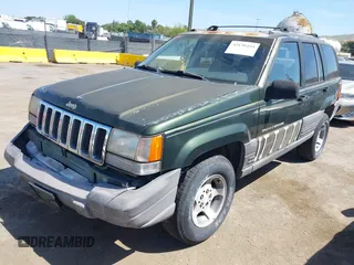 1996 Jeep Grand Cherokee Laredo with VIN 1J4GZ58S7TC280276, listed as a IAAI auction lot 42120454 with 230,617 mi miles. Bid and sale history available at carsss.com. Image 2.