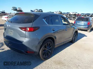 2021 Mazda CX-5 Touring with VIN JM3KFACM1M0371354, listed as a IAAI auction lot 40938490 with 56,172 mi miles. Bid and sale history available at carsss.com. Image 4.