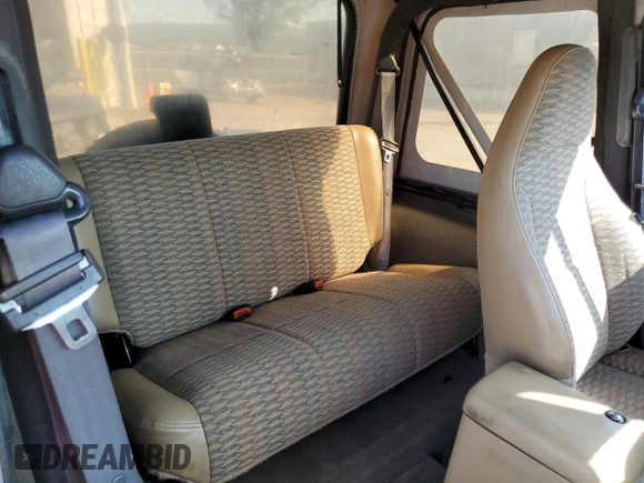 1999 Jeep Wrangler Sport with VIN 1J4FY19S6XP445867, listed as a Copart auction lot 62223125 with 146,037 mi miles and Salvage title. Bid and sale history available at DreamBid. Image 11.