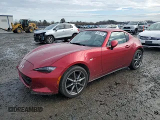2021 Mazda MX-5 Miata Grand Touring with VIN JM1NDAM79M0457435, listed as a Copart auction lot 84282144 with 27,816 mi miles and Salvage title. Bid and sale history available at DreamBid. Image 1.
