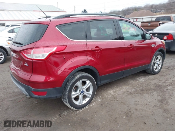2014 Ford Escape SE with VIN 1FMCU9GX7EUC35483, listed as a IAAI auction lot 41704298 with 105,017 mi miles. Bid and sale history available at carsss.com. Image 4.