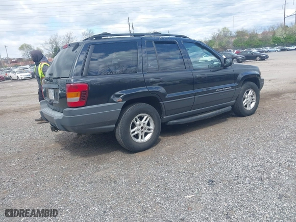 2003 Jeep Grand Cherokee Laredo with VIN 1J8GW48S63C596866, listed as a IAAI auction lot 42060430 with 129,849 mi miles. Bid and sale history available at carsss.com. Image 4.