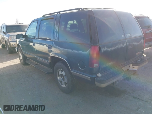 1997 GMC Yukon with VIN 1GKEK13R1VJ723409, listed as a IAAI auction lot 41512184 with 235,988 mi miles. Bid and sale history available at carsss.com. Image 3.