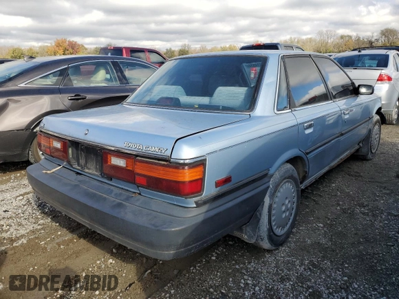1990 Toyota Camry DLX z VIN 4T1SV21E8LU165609, wystawiony jako Copart lot #79314534 z przebiegiem 153 006 mil mil oraz Szkoda całkowita • Salvage title. Historia ofert i sprzedaży dostępna na DreamBid. Obrazek 3.