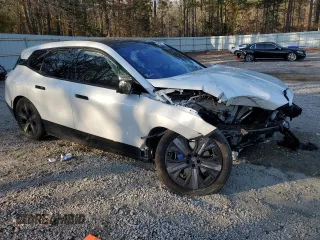 2025 BMW iX xDrive50 with VIN WB523CF0XSCS62033, listed as a Copart auction lot 42503325 with 7,294 mi miles and Salvage Title. Bid and sale history available at carsss.com. Image 4.
