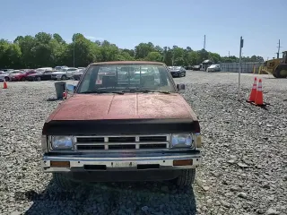 1991 Nissan Frontier XE with VIN 1N6SD11S2MC412375, listed as a Copart auction lot 61015515 with 201,629 mi miles and Salvage title. Bid and sale history available at DreamBid. Image 13.