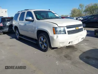 2014 Chevrolet Tahoe LTZ with VIN 1GNSKCE0XER128575, listed as a IAAI auction lot 42009959 with 129,628 mi miles and . Bid and sale history available at DreamBid. Image 1.