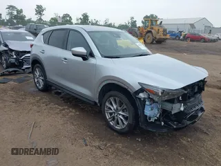 2021 Mazda CX-5 Grand Touring with VIN JM3KFBDM4M0371496, listed as a IAAI auction lot 42428860 with 113,735 mi miles and . Bid and sale history available at DreamBid. Image 1.