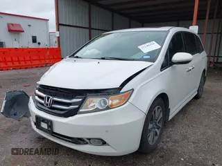 2014 Honda Odyssey Touring with VIN 5FNRL5H95EB059729, listed as a IAAI auction lot 42148110 with 135,304 mi miles and . Bid and sale history available at DreamBid. Image 2.