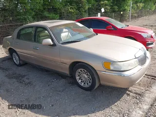 1998 Lincoln Town Car Signature with VIN 1LNFM82WXWY618589, listed as a IAAI auction lot 42176624 with 176,606 mi miles and . Bid and sale history available at DreamBid. Image 1.