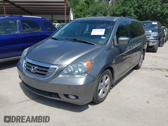 2010 Honda Odyssey Touring with VIN 5FNRL3H90AB053710, listed as a IAAI auction lot 42577646 with 255,351 mi miles and . Bid and sale history available at DreamBid. Image 2.