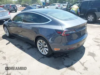 2020 Tesla Model 3 Standard Range Plus with VIN 5YJ3E1EAXLF615781, listed as a IAAI auction lot 42068935 with 96,026 mi miles. Bid and sale history available at carsss.com. Image 3.