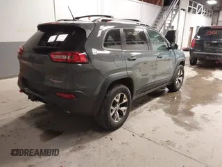 2015 Jeep Cherokee Trailhawk with VIN 1C4PJMBS6FW724931, listed as a IAAI auction lot 41602181 with 153,340 mi miles and . Bid and sale history available at carsss.com. Image 4.