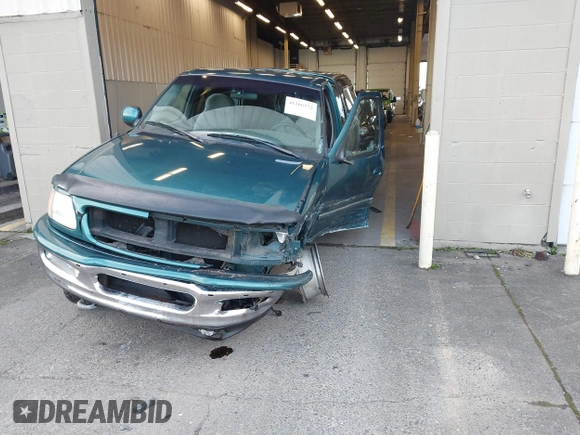 1997 Ford F-150 XL with VIN 1FTEX18L1VKB44867, listed as a IAAI auction lot 41266572 with 105,061 mi miles. Bid and sale history available at carsss.com. Image 2.