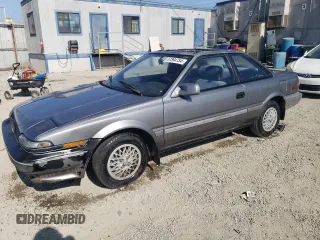 1990 Toyota Corolla z VIN JT2AE96J0L3382052, wystawiony jako Copart lot #57894754 z przebiegiem 90 550 mil mil oraz Czysty tytuł • Clean title. Historia ofert i sprzedaży dostępna na DreamBid. Obrazek 1.