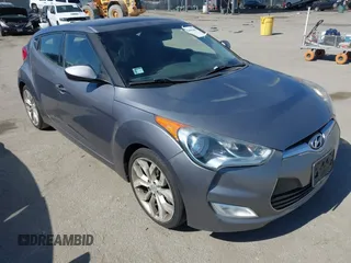 2013 Hyundai Veloster w/Black Int with VIN KMHTC6AD5DU095867, listed as a IAAI auction lot 42698380 with 115,528 mi miles and . Bid and sale history available at DreamBid. Image 1.