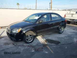 2010 Kia Rio LX with VIN KNADH4A33A6668719, listed as a IAAI auction lot 41777544 with 124,400 mi miles. Bid and sale history available at carsss.com. Image 2.