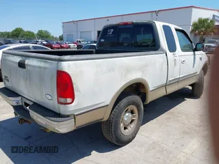 1999 Ford F-150 XL with VIN 2FTRX18L8XCB22793, listed as a IAAI auction lot 42016740 with 198,056 mi miles. Bid and sale history available at carsss.com. Image 4.