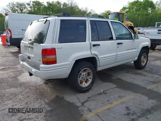 1998 Jeep Grand Cherokee Limited with VIN 1J4GZ78Y2WC164021, listed as a IAAI auction lot 42109012 with 1 mi miles. Bid and sale history available at carsss.com. Image 4.