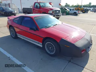 1986 Pontiac Fiero z VIN 1G2PG9791GP267415, wystawiony jako IAAI lot #42461769 z przebiegiem Nie podano mil oraz . Historia ofert i sprzedaży dostępna na DreamBid. Obrazek 1.