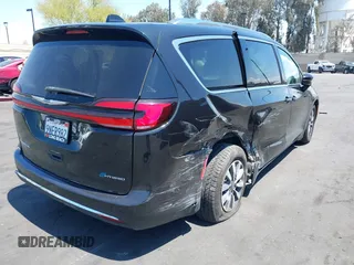 2021 Chrysler Pacifica Hybrid Touring L with VIN 2C4RC1L71MR599631, listed as a IAAI auction lot 42151965 with 67,401 mi miles and . Bid and sale history available at DreamBid. Image 4.