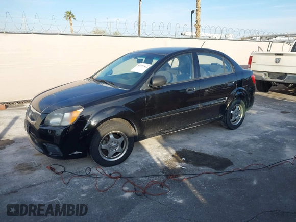 2010 Kia Rio LX with VIN KNADH4A33A6668719, listed as a IAAI auction lot 41777544 with 124,400 mi miles. Bid and sale history available at carsss.com. Image 2.