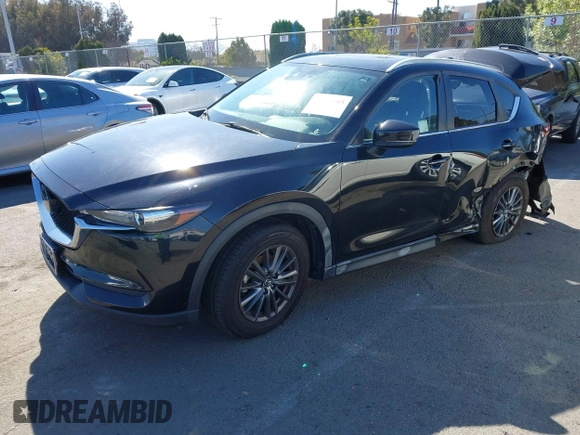 2021 Mazda CX-5 Touring with VIN JM3KFACM2M0339349, listed as a IAAI auction lot 41651005 with 53,792 mi miles. Bid and sale history available at carsss.com. Image 2.