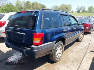 2003 Jeep Grand Cherokee Laredo with VIN 1J4GX48S83C548090, listed as a IAAI auction lot 42039918 with 243,209 mi miles. Bid and sale history available at carsss.com. Image 4.