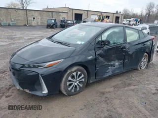 2021 Toyota Prius LE with VIN JTDKAMFP2M3165859, listed as a IAAI auction lot 41943098 with 20,306 mi miles and . Bid and sale history available at DreamBid. Image 2.