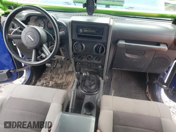 2009 Jeep Wrangler X with VIN 1J4FA24179L700884, listed as a Copart auction lot 52194055 with 96,189 mi miles and Salvage Title. Bid and sale history available at DreamBid. Image 8.