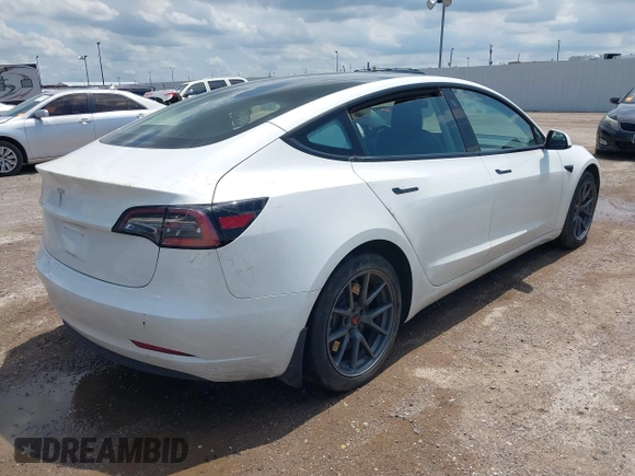 2023 Tesla Model 3 with VIN 5YJ3E1EA5PF407054, listed as a IAAI auction lot 42313770 with 57,621 mi miles and . Bid and sale history available at DreamBid. Image 4.