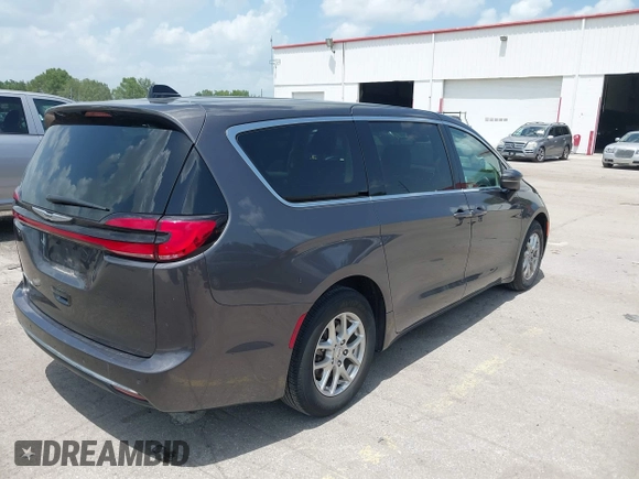 2023 Chrysler Pacifica Touring L with VIN 2C4RC1BG6PR590302, listed as a IAAI auction lot 42451369 with 72,097 mi miles and . Bid and sale history available at DreamBid. Image 4.