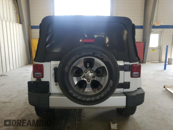 2016 Jeep Wrangler Unlimited Sahara with VIN 1C4BJWEGXGL310499, listed as a Copart auction lot 59756015 with 128,498 mi miles and Salvage title. Bid and sale history available at DreamBid. Image 6.