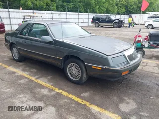 1987 Chrysler LeBaron z VIN 1C3CJ41E8HG125699, wystawiony jako IAAI lot #42534557 z przebiegiem 104 702 mil mil oraz . Historia ofert i sprzedaży dostępna na DreamBid. Obrazek 1.