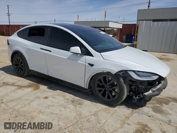 2022 Tesla Model X with VIN 7SAXCBE52NF362994, listed as a Copart auction lot 49850475 with 55,506 mi miles and Salvage Title. Bid and sale history available at DreamBid. Image 4.