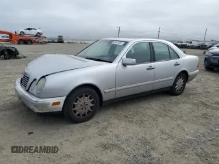 1999 Mercedes-Benz E-Class with VIN WDBJF65H0XA797390, listed as a Copart auction lot 55081405 with 80,950 mi miles and Salvage Title. Bid and sale history available at carsss.com. Image 1.