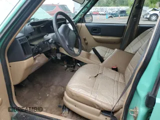 1999 Jeep Cherokee SE with VIN 1J4FF28SXXL641556, listed as a Copart auction lot 62605065 with Not provided miles and Salvage title. Bid and sale history available at DreamBid. Image 7.