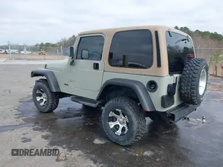 1999 Jeep Wrangler Sahara with VIN 1J4FY49S0XP480017, listed as a IAAI auction lot 41642577 with 154,068 mi miles. Bid and sale history available at carsss.com. Image 3.
