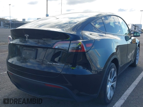 2022 Tesla Model Y Long Range with VIN 7SAYGAEE4NF522330, listed as a IAAI auction lot 42046691 with 59,980 mi miles and . Bid and sale history available at carsss.com. Image 4.