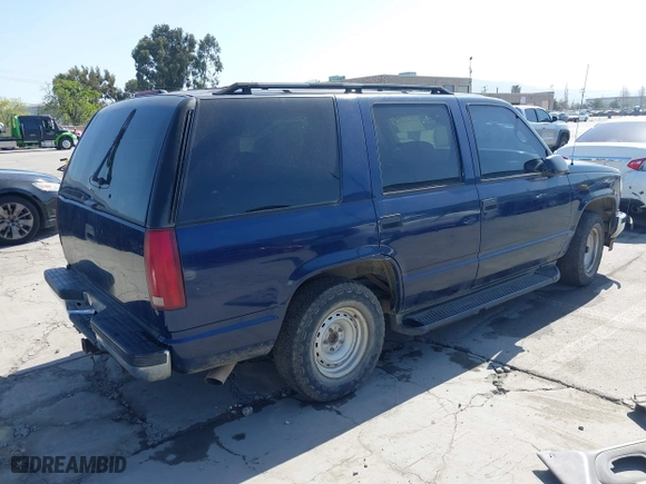 1999 Chevrolet Tahoe with VIN 1GNEC13R7XJ573387, listed as a IAAI auction lot 42001191 with 241,007 mi miles. Bid and sale history available at carsss.com. Image 4.