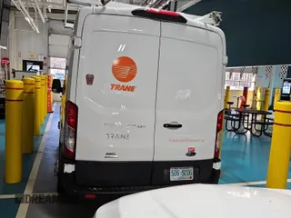2021 Ford Transit Cargo with VIN 1FTBR2CG0MKB03044, listed as a IAAI auction lot 42232122 with 100,199 mi miles and . Bid and sale history available at carsss.com. Image 1.