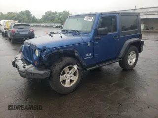 2009 Jeep Wrangler X with VIN 1J4FA24109L712701, listed as a Copart auction lot 60800855 with 156,709 mi miles and Salvage title. Bid and sale history available at DreamBid. Image 1.